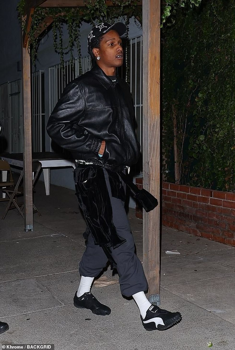 77714635 12740807 Rapper The rapper wore grey sweatpants with a black leather jack a 10 1699829401198