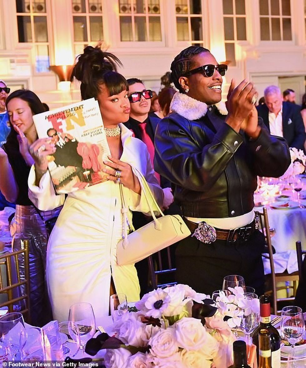 92820919 14168967 Rihanna held up her partner s award a 32 1733597906985