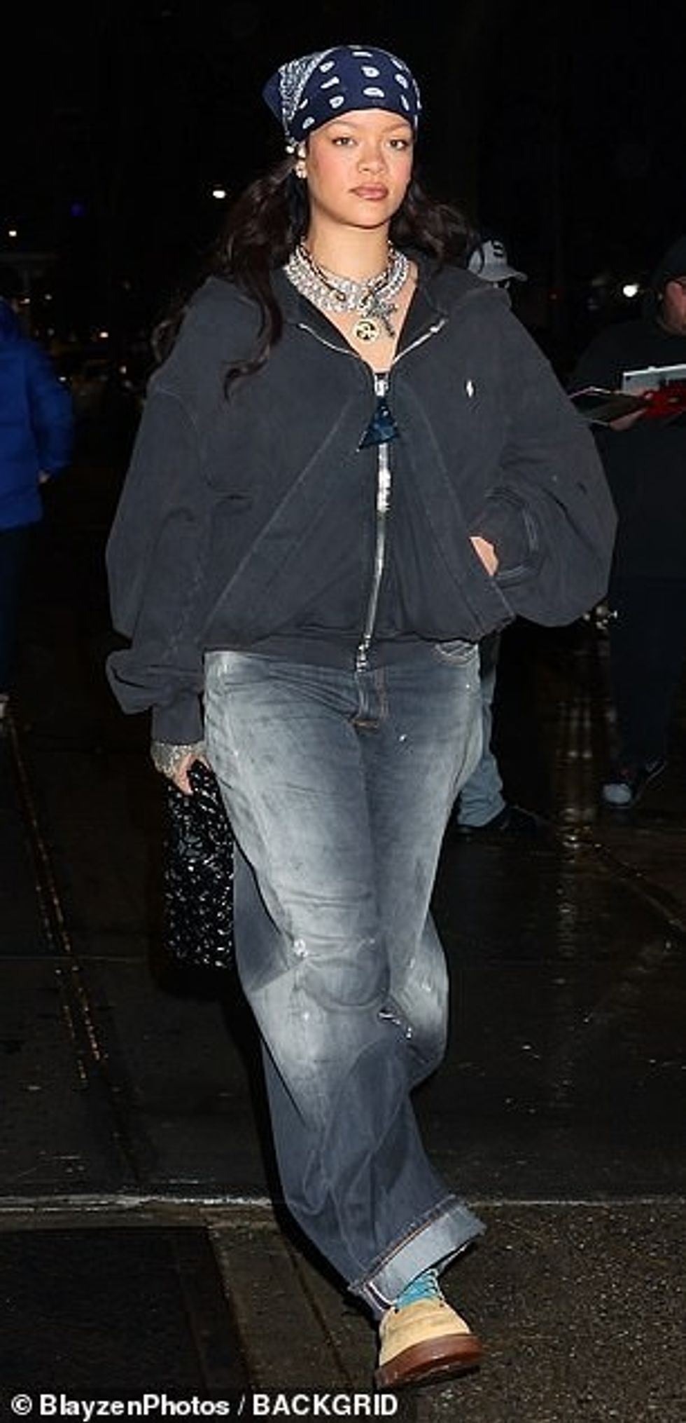 93552671 14233393 The star kept warm in the cooler drizzly weather in a gray hoode a 60 1735460752943