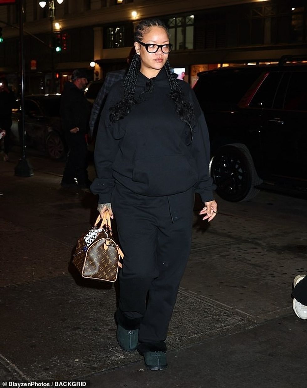 94220507 14297659 Rihanna wore her hair in long black cornrows that cascaded down a 12 1737142759563