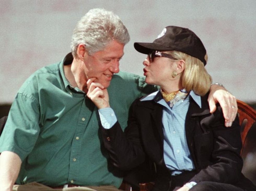 97 First lady Hillary Rodham Clinton, right, squeezes the chin of President Clinton during the kick-off rally for The President's Summit for America's Future at Marcus Foster Stadium in Philadelphia, Sunday, April 27, 1997. (AP Photo/Tim Shaffer)
