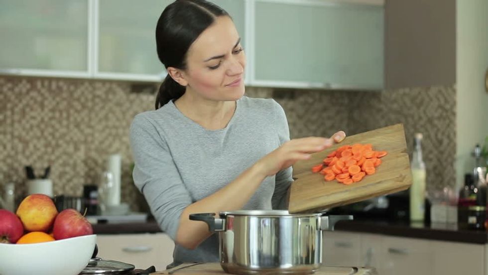 a chef in the kitchen with pots pans and healthy vegetables 1