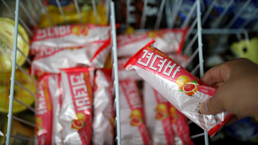 A clerk arranges ice cream bars named Gyeondyo-bar, which translates to