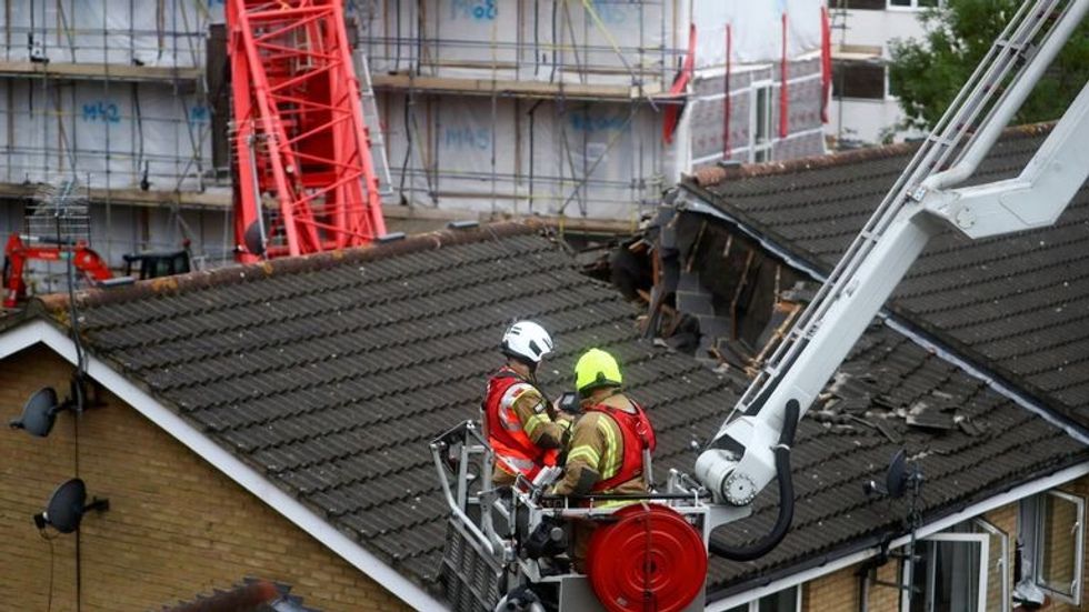 A collapsed crane is seen near a construction site in Bow, east London, Britain, July 8, 2020. REUTERS/Hannah McKay