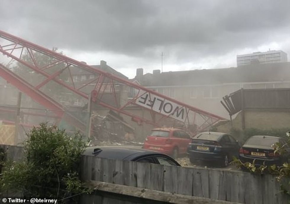 A crane has collapsed in east London reportedly destroying two houses and leaving one man seriously injured