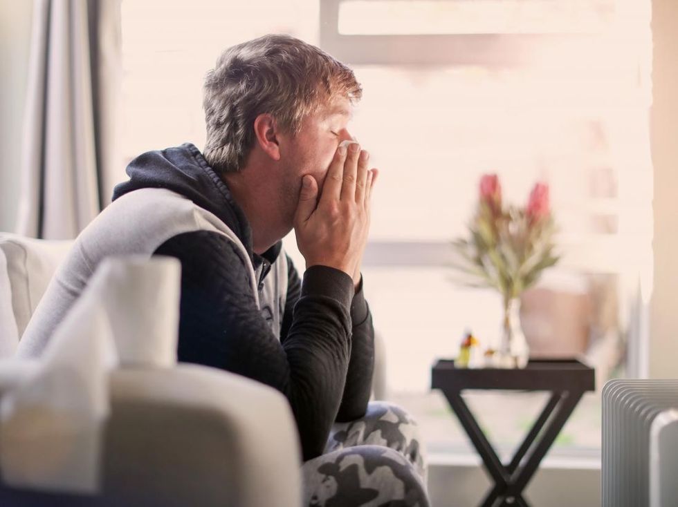 a man experiencing heavy breathing from a fever or overheating