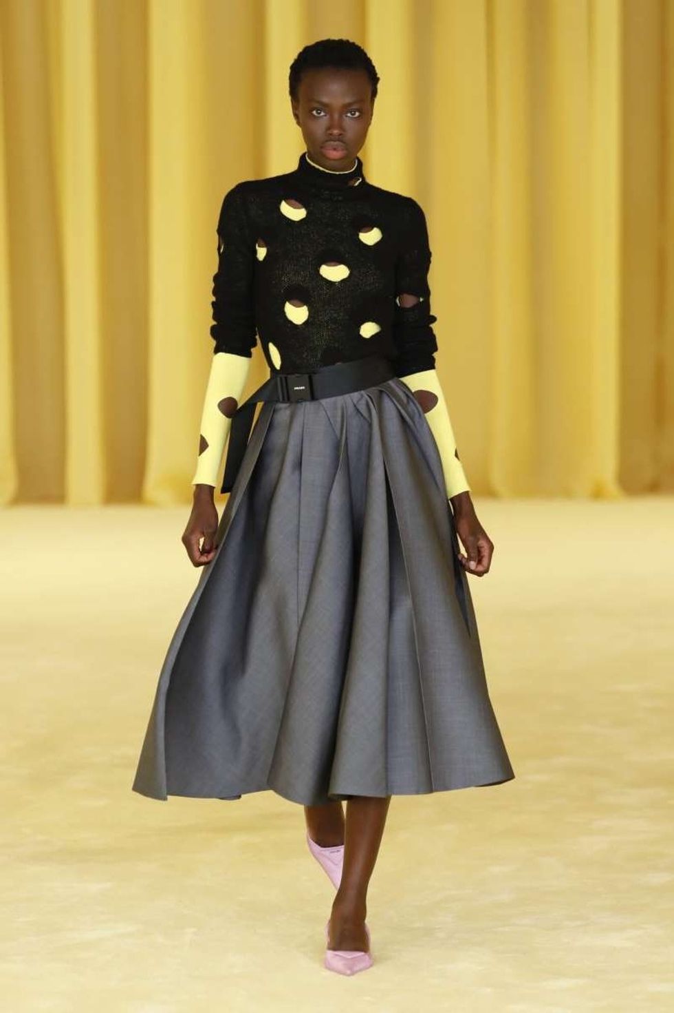 a person standing in front of a curtain prada 653982