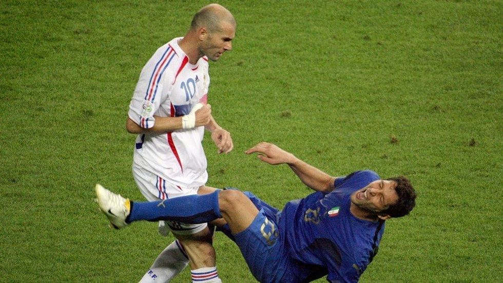 A photo taken 09 July 2006 shows French midfielder Zinedine Zidane (L) gesturing after head-butting Italian defender Marco Materazzi during the World Cup 2006 final football match between Italy and France at Berlin?s Olympic Stadium. AFP PHOTO JOHN MACDOUGALL (Photo credit should read JOHN MACDOUGALL/AFP/Getty Images)