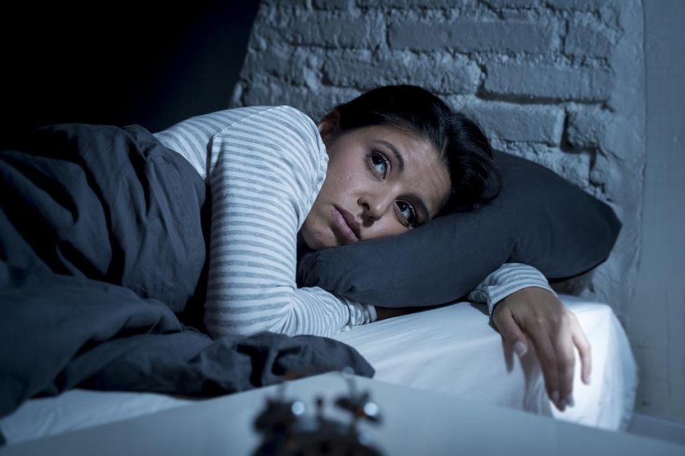 a woman in bed unable to sleep