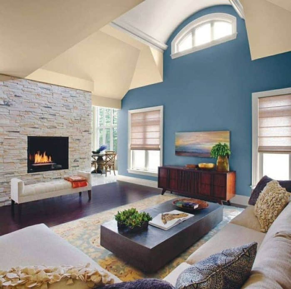 accent walls in living room blue color and faux stacked fireplace