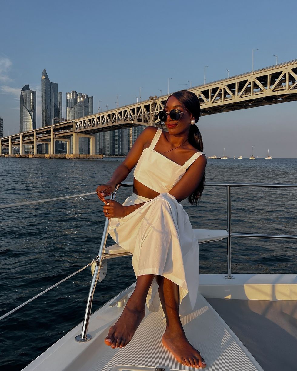 @aidabadji_ sitting on a boat with a milky pedicure