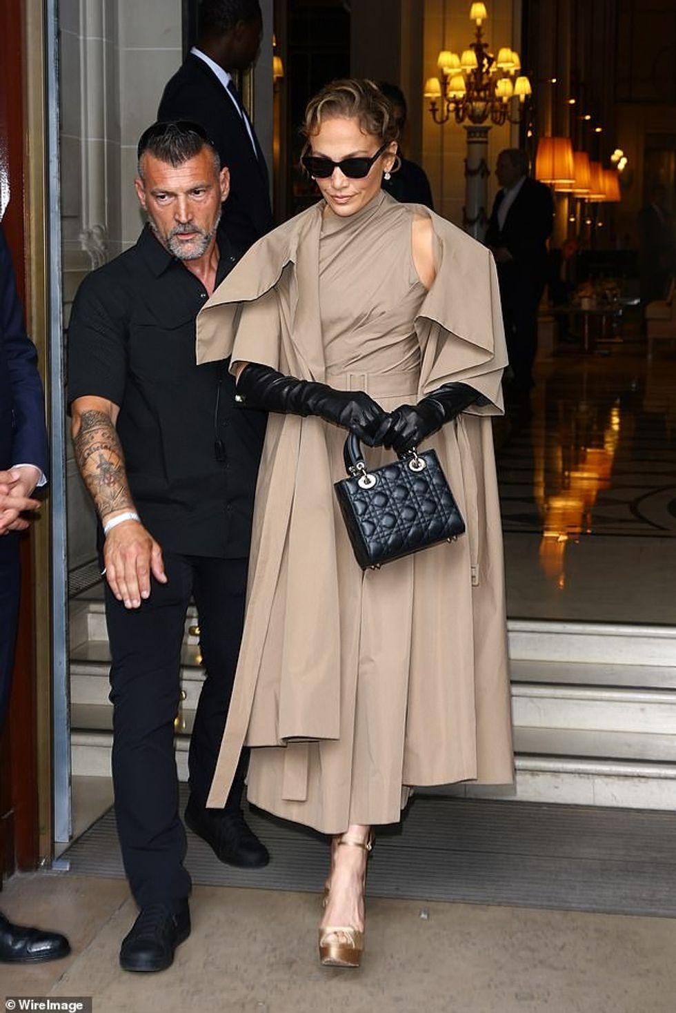 Ajo shtoi një rrip që përputhet me belin e saj të vogël dhe stiletat prej sateni të artë, ndërsa mbante një çantë të zezë me tegela.