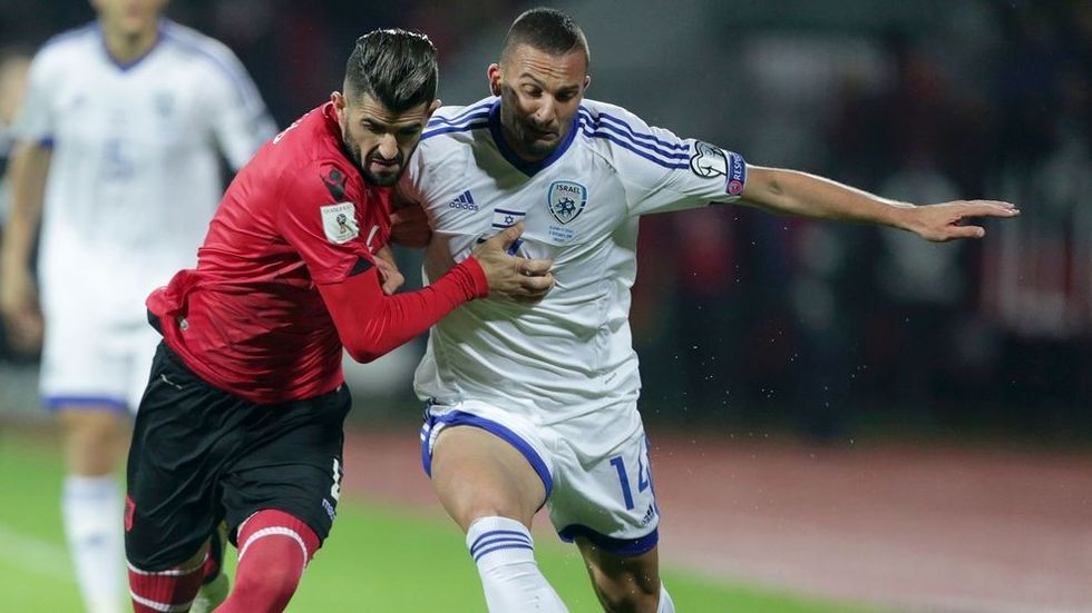 Albania's Elseid Hysaj (L) vies with Israel's Ben Sahar during the 2018 World Cup group G qualifying football match between Albania and Israel, in Elbasan on November 12, 2016..Israel said on November 8, 2016 that the Islamic State group had been planning attacks