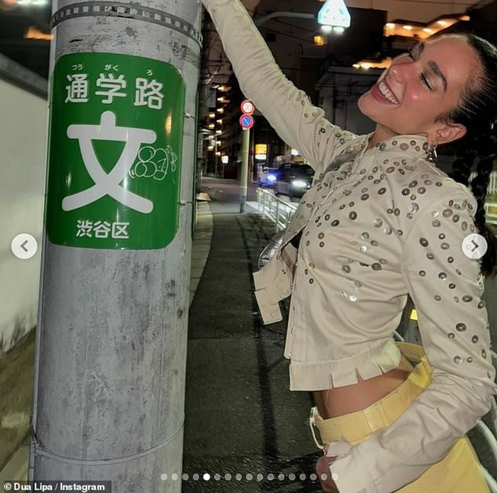 And at one point, the Barbie star posed gleefully up against a pole bearing a sign in the country's language