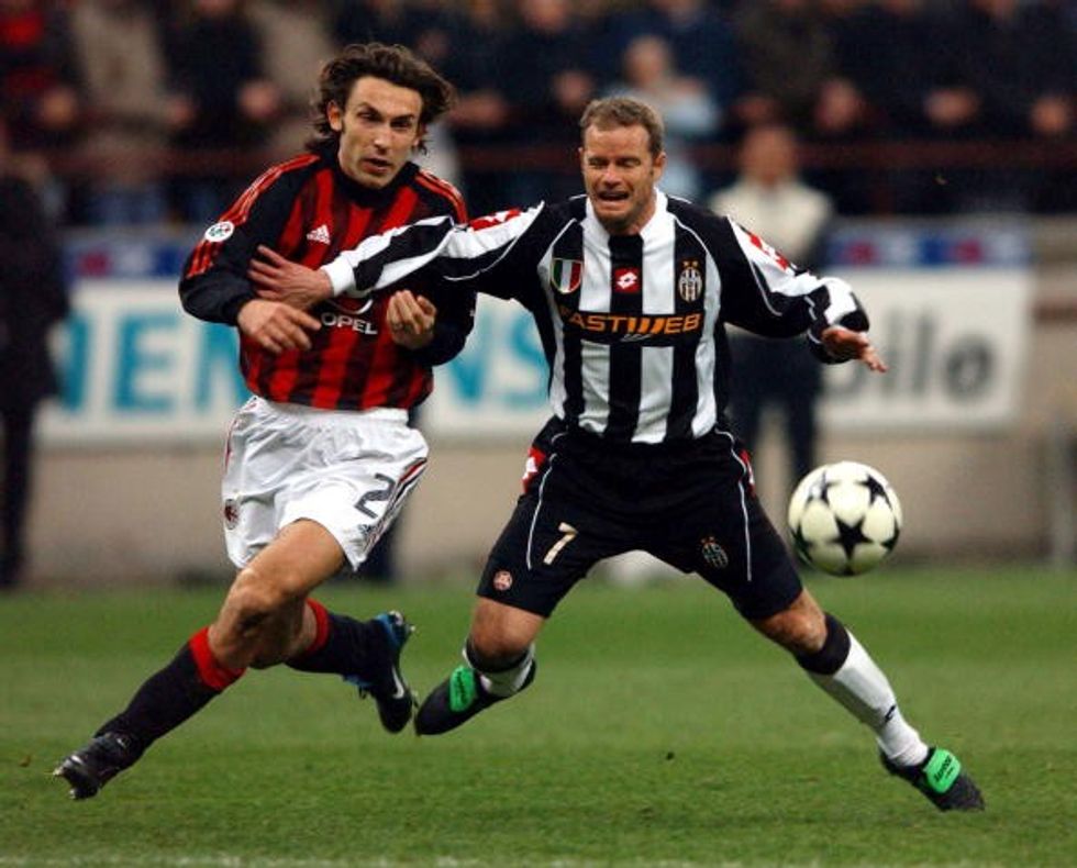 Andrea Pirlo of AC Milan and Gianluca Pessotto of Juventus in action