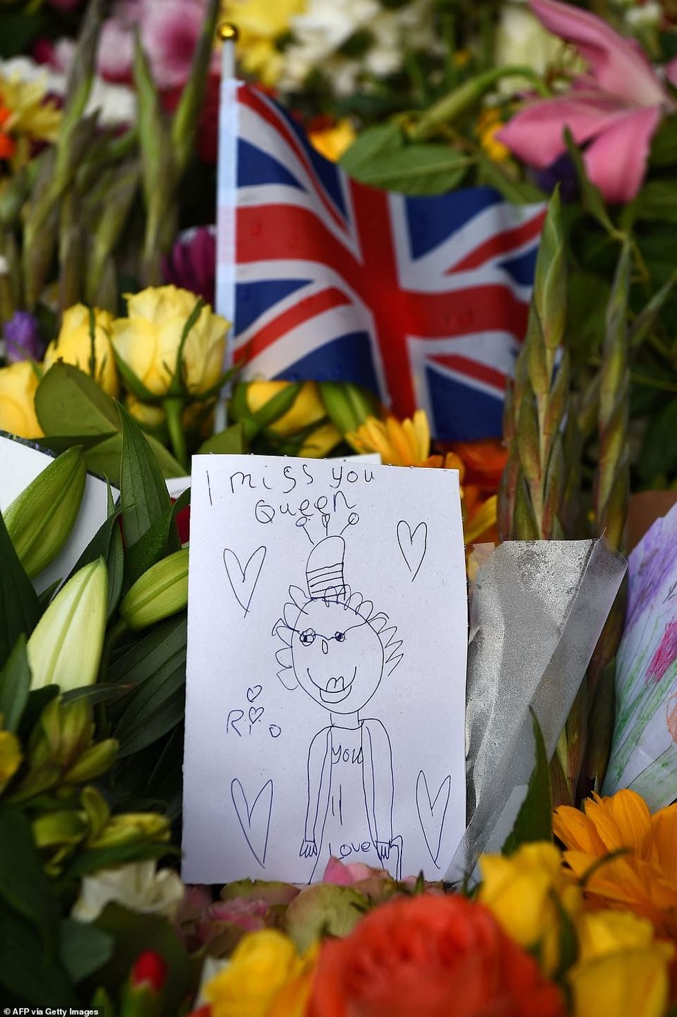 Another tribute left among flowers at Balmoral Castle read 'I miss you Queen' on a child's drawing of the late monarch