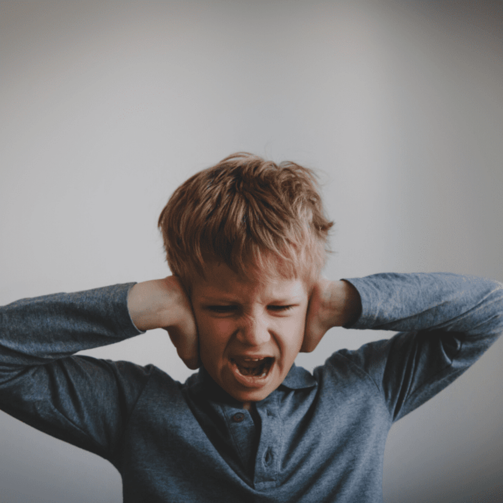 anxious child covering his ears 1