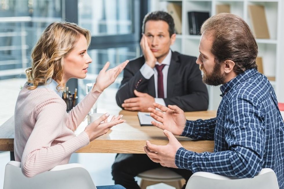 Arguing Divorced Couple Mediate In Law Office