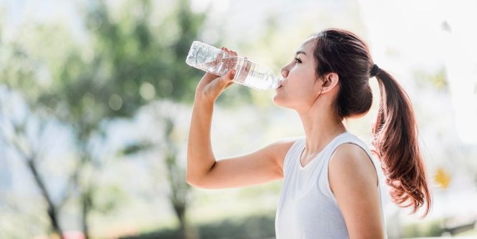 Asian female drinking water AdobeStock 192899502