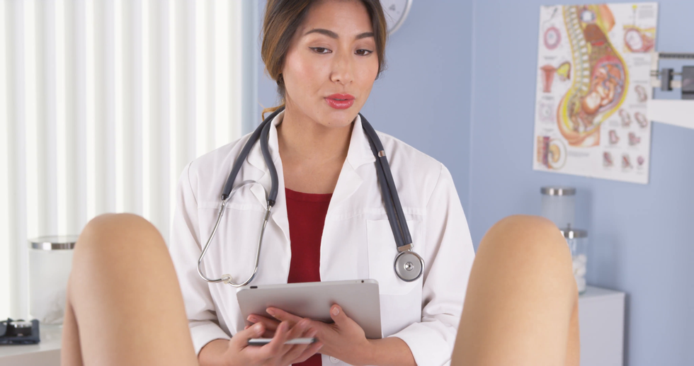 asian obgyn talking to patient in exam room ekf 1fqg l F0000