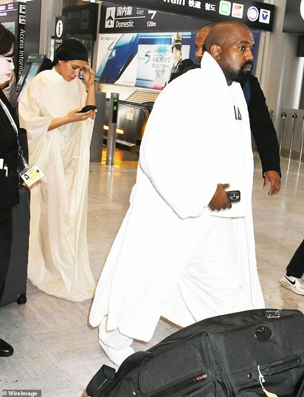 At the airport on June 9, Censori wore a more-opaque version of her cloak while West wore the same shirt