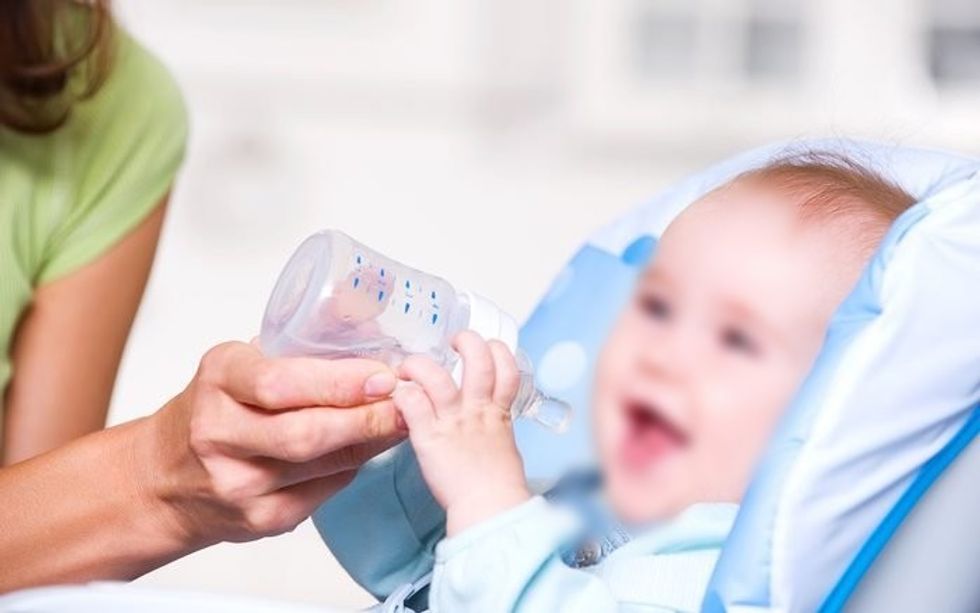 baby with water in sippy cup shutterstock 60947779