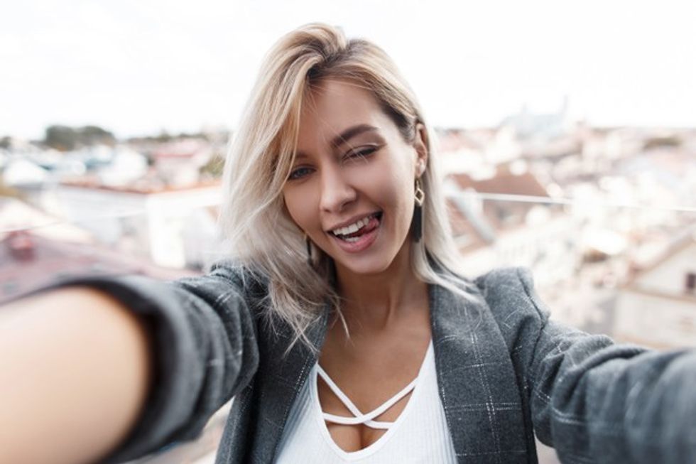 beautiful happy young fashionable girl shows tongue makes selfie city woman is traveling taking photo phone 338491 4478