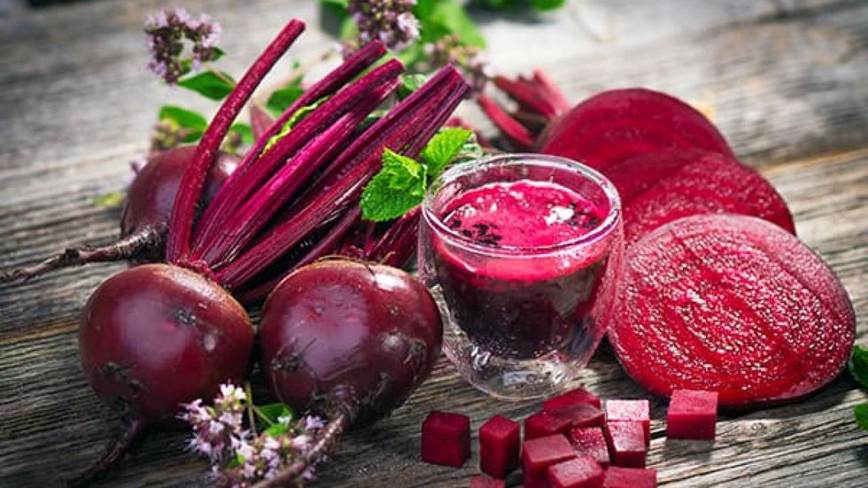 beetroot on a board and beet juice may help with ed