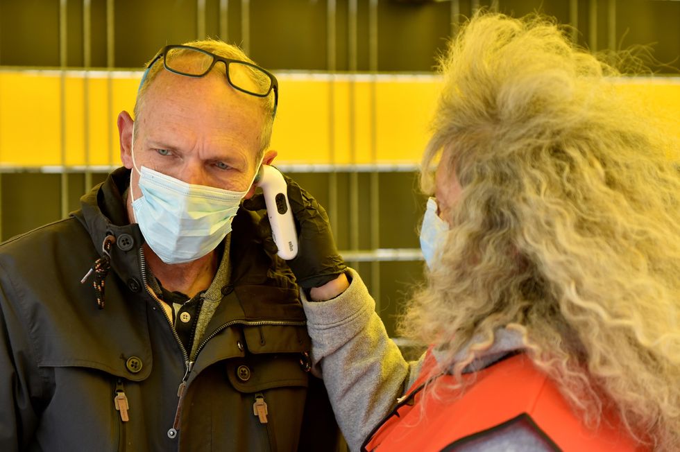 Before entering, people had their temperature taken (REUTERS)