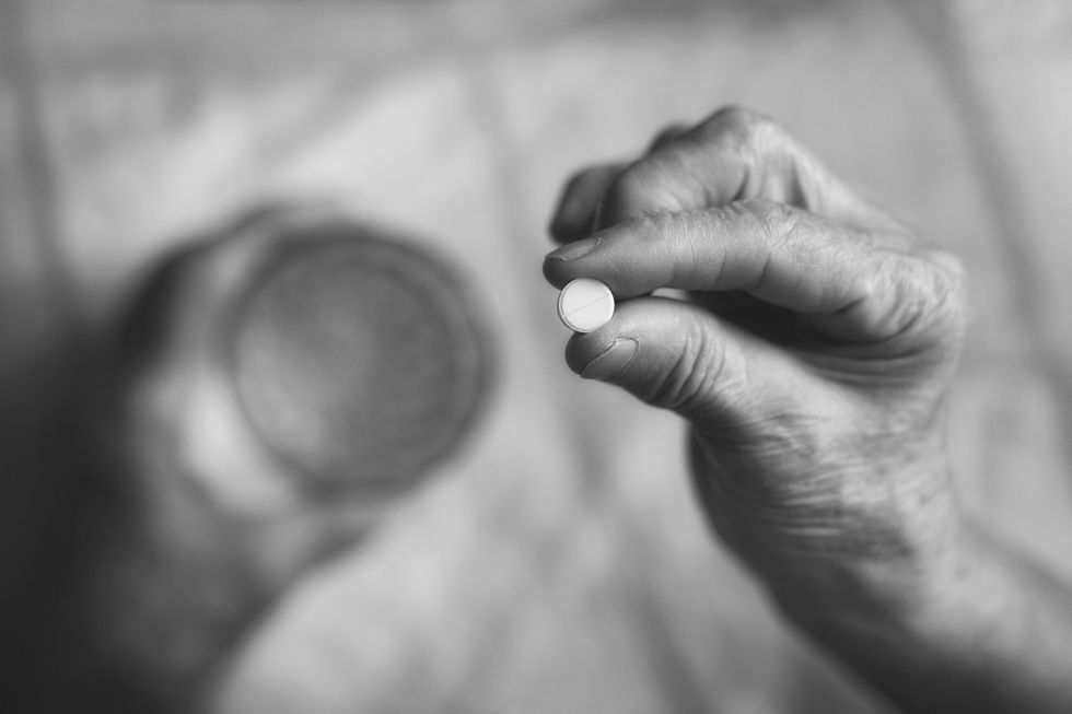 bigstock An Elderly Woman Takes A Pill 286164214