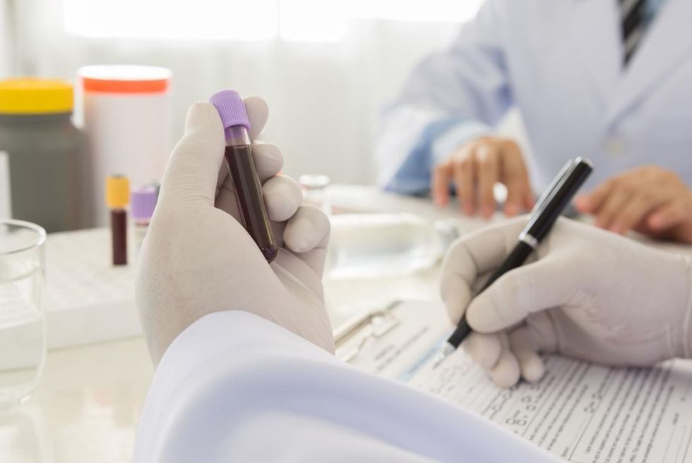 blood sample being tested by lab technician
