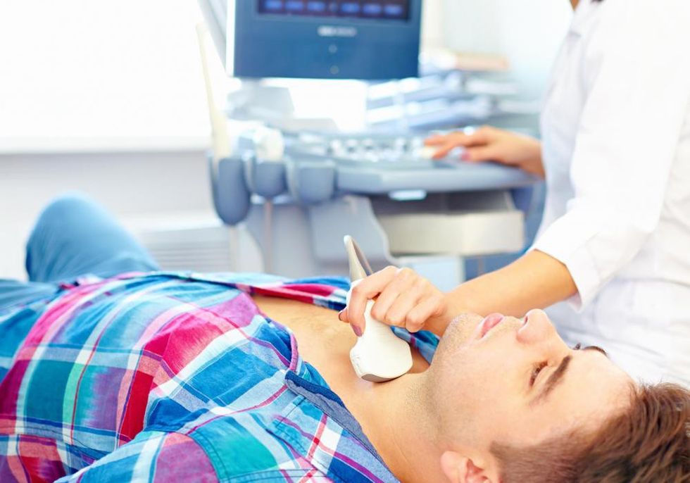 boy in checkered shirt getting ultrasound of thyroid