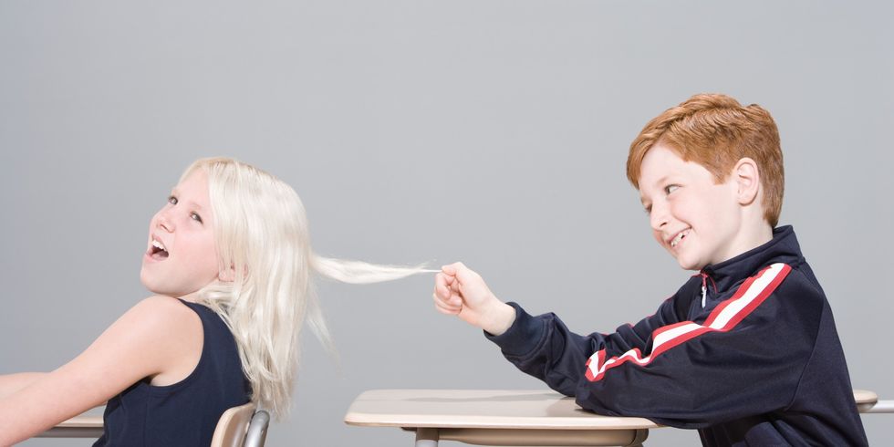 Boy pulling girl's hair