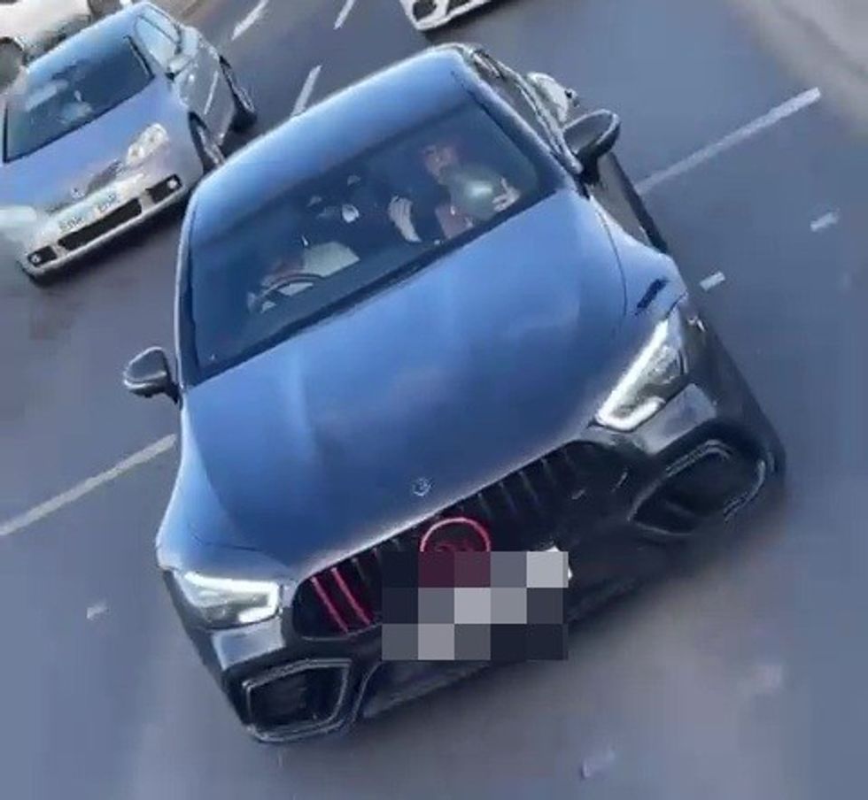 Brandon Williams appears to inhale 'hippy crack' from a balloon while in the passenger seat of a Mercedes Brabus