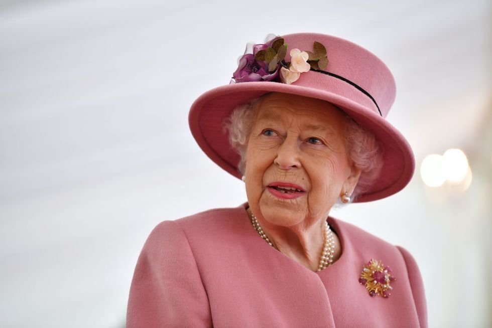 britains queen elizabeth ii speaks with staff during a news photo 1634851498