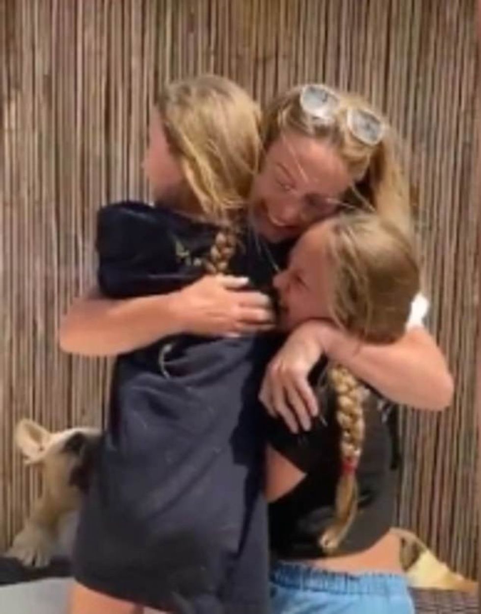 British mother Suzanne, was filmed reuniting with her daughters Bella, nine, and Hettie, seven, (pictured) after spending nine weeks apart