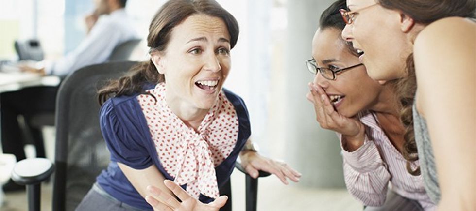 Businesswomen gossiping in office