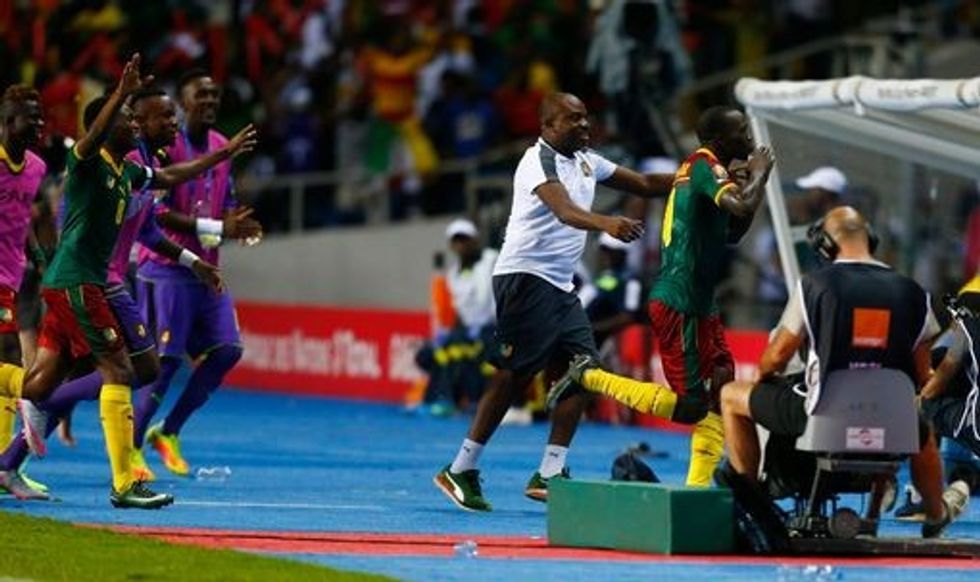 Cameroons Vincent Aboubakar celebrates scoring their second goal with teammates and staff