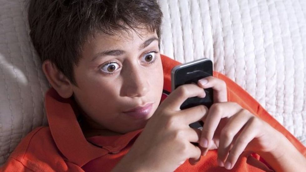 child gaming on smartphone
