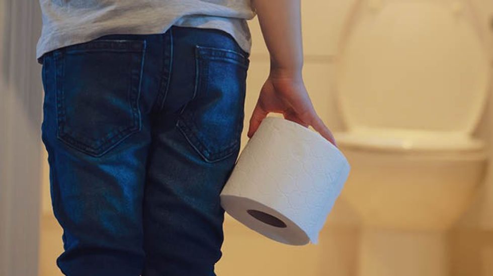 child holding toilet paper roll
