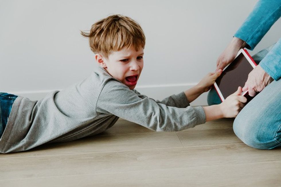 child not letting go of mobile device