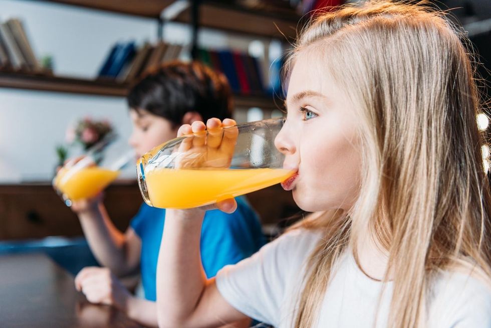 children drinking orange juice