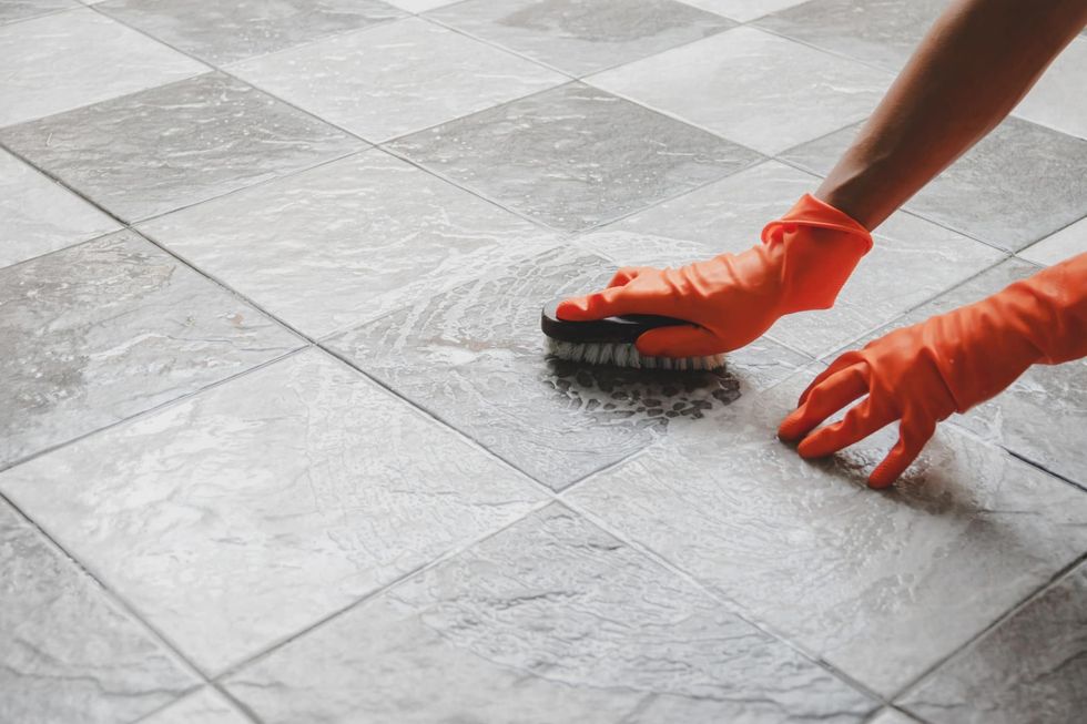 cleaning tiles with a brush scaled 1
