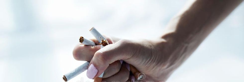 closeup female hand holding ciga
