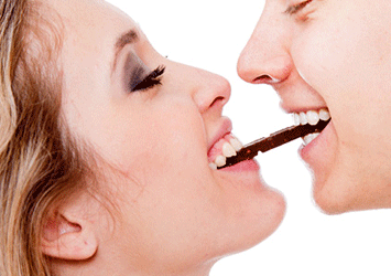 couple eating chocolate bar together