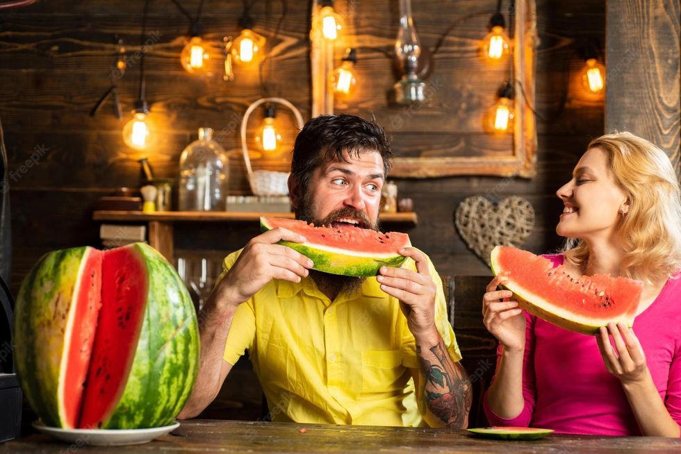 couple eating watermelon kitchen man woman eat watermelon home happy couple eating watermelon husband cutting slices watermelon wife 265223 39998