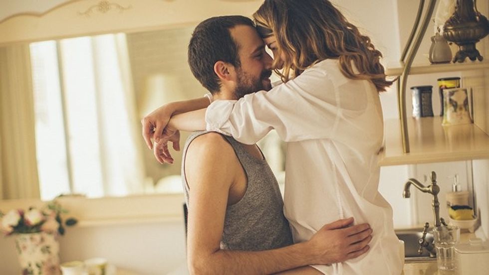 couple getting it on in the kitchen
