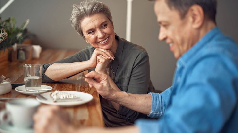 couple having chatting with cheerful friend