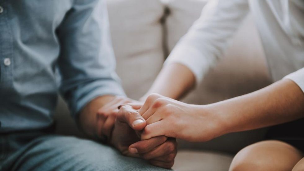 couple holding hands while discussing bipolar and relationships