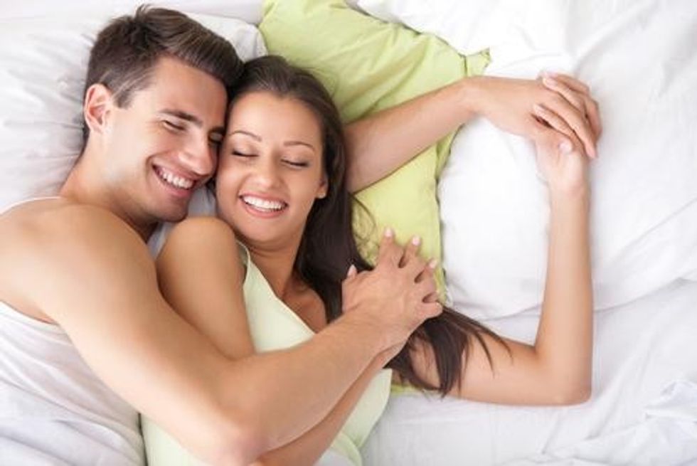 couple hugging bed